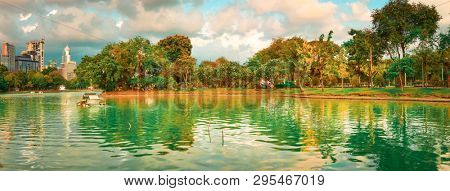 Panoramic view of Bangkok skyline, Thailand. View from Lumphini park. Pond on the foreground