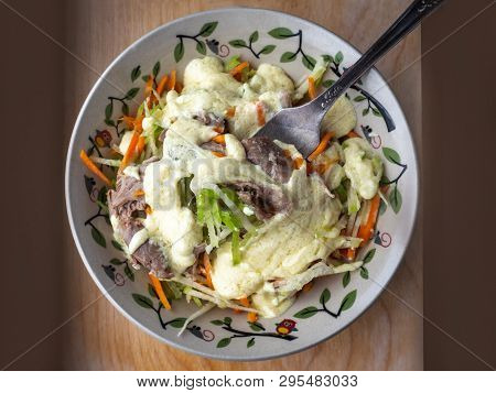 Easy Deeth Salad Of Green Radish, Carrots And Turkey In A Deep Decorative Plate, Seasoned With A Spi