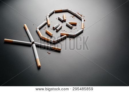 Skull From Cigarettes On A Black Background. The Concept Of Smoking Kills. Toward The Concept Of Smo