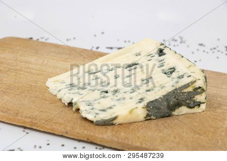 Closeup On A Slice Of Roquefort On A Wooden Tray