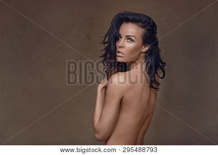 Beautiful Sexy Naked Middle-aged Woman Turning To Look Back At The Camera Over One Shoulder With A S