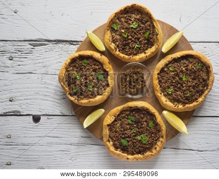Arabic Meat Sfiha Over A Wooden Table. Top View Of Arabic Esfiha.