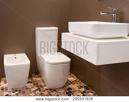 Modern Interior Design Of Hotel Bathroom With Washbasin, Toilet And Bidet