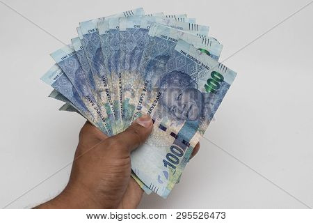 Hand Holding South African Rands