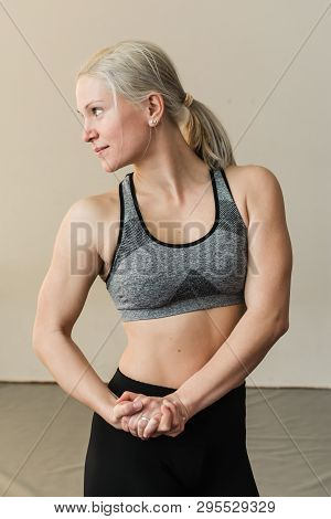 Beautiful Blonde Female Trainer Showing Her Muscels. Healthy, Active Lifestyle, Losing Weight. Women