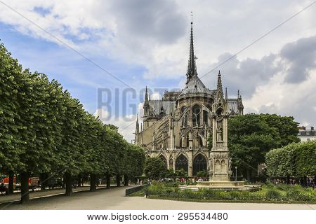 Exhaulted Horizontal View Of Interior Of Notre Dame Of Paris, France In Golden Lights On Ancient Sto