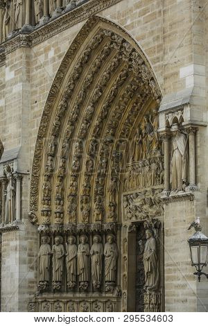 Exhaulted Horizontal View Of Interior Of Notre Dame Of Paris, France In Golden Lights On Ancient Sto