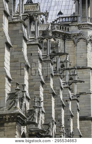 Exhaulted Horizontal View Of Interior Of Notre Dame Of Paris, France In Golden Lights On Ancient Sto