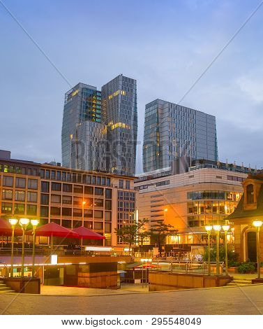 Evening Cityscape Of Frankfurt With Illuminated Downtown View, Modern Skyskrapers And Restaurants, F