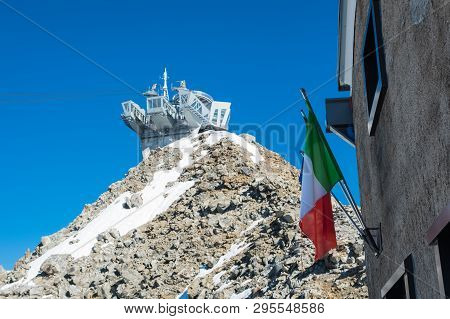 Cableway Station Punta Helbronner In The Blue Sky  With Italian Flag