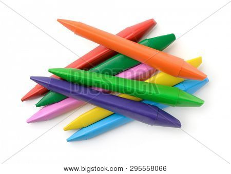 Top view of colorful plastic double sided crayons isolated on white