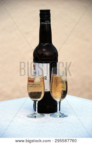 Spain - August 21, 2008 - Two Glasses Of Fino Sherry With The Bottle To The Rear, Andalusia, Spain, 