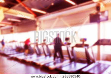 Blurred Background With Fitness Gym People Cardio Workout In Sport Club Center. Blurred Picture Of R