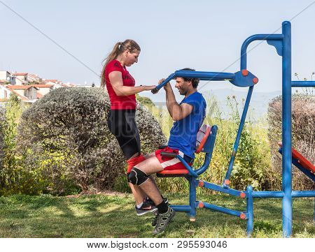 Safed, Israel, April 13, 2019 : Two Athletes Perform Paired Exercises On Outdoor Public Exercise Mac