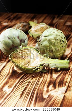 Artichokes On Rustic Background. Fresh Organic Artichoke Flower Set