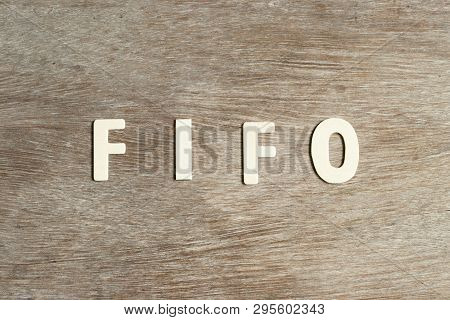 Alphabet Letter In Word Fifo (abbreviation Of First In First Out) On Wood Background