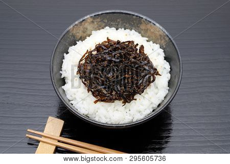 Japanese Food, Tsukudani Of Konbu On Cooked White Rice On Black Background