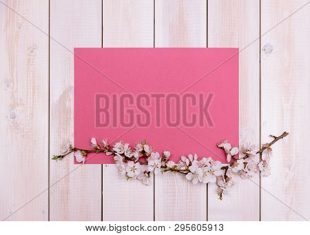 Apricot Branches With Flowers And Candle On A Plate On A Wooden Background