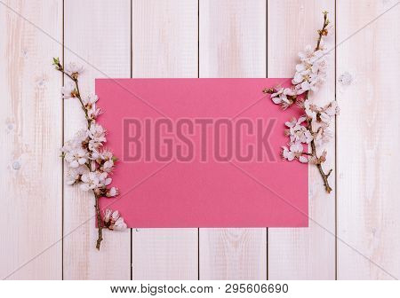 Apricot Branches With Flowers And Candle On A Plate On A Wooden Background