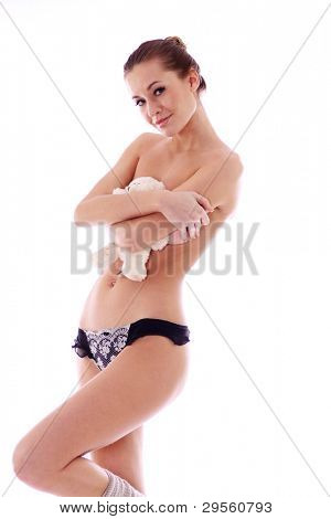 Topless girl hides behind  teddy bear