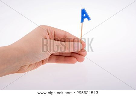 Color Candle In Hand On Sticks Writes The Lettera