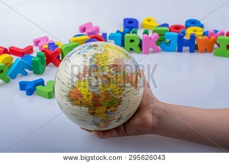 Little Model Gobe In Hand With Colorful Letters Behind