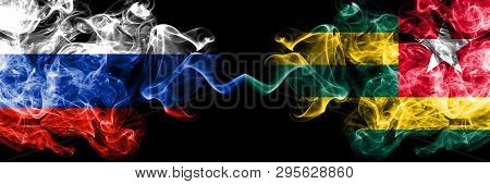 Russian Vs Togo, Togolese Smoke Flags Placed Side By Side. Thick Colored Silky Smoke Flags Of Russia