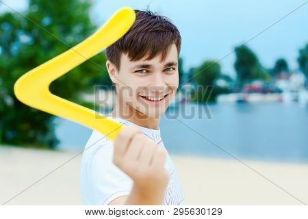 Young Smiling Woman In Light Clothes Is Holding White Racket And Ball In Her Hands. Cheerful Female 