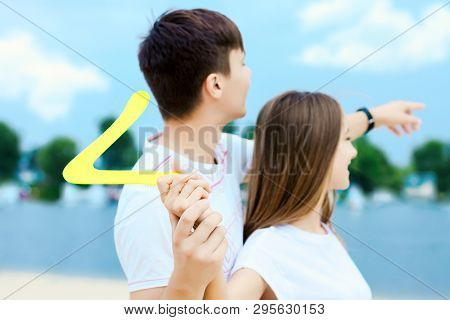 Young Smiling Woman In Light Clothes Is Holding White Racket And Ball In Her Hands. Cheerful Female 