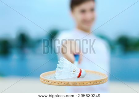 Young Smiling Woman In Light Clothes Is Holding White Racket And Ball In Her Hands. Cheerful Female 