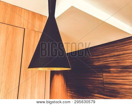 Black Decorative Lamp Hangs From The Ceiling. A Modern Chandelier At Home