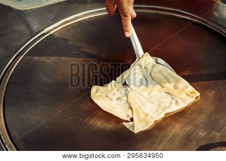 Hands Of Street Vendor Cooking Thai Style Sweet Roti Bread On Steel Roti Pan Or Big Flat Frying Pan.