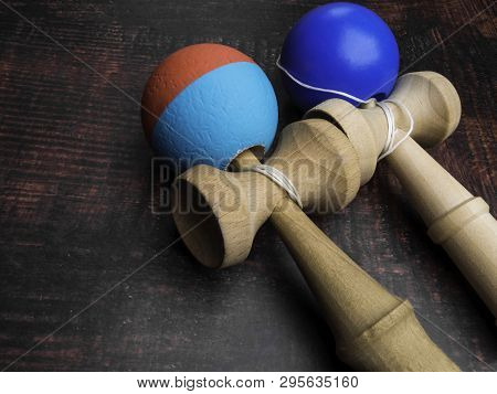Classic Japanese Game Kendama On Wooden Background. Two Playing Kendamas, New And Used