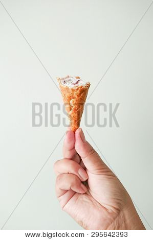 Female Hand Fingers Hold Waffle Cone With Ice Cream. Yami Sweet Food Summer Season Concept