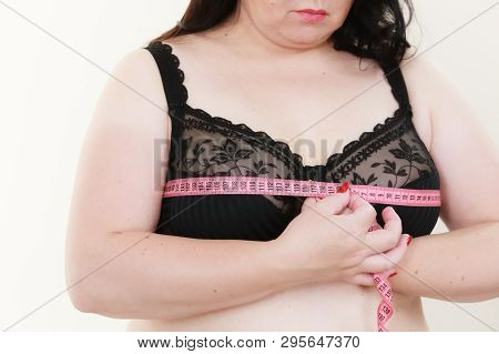 Plus Size Fat Woman Wearing Black Bra Using Tape Measure To Check The Measurements Of Her Big Chest 