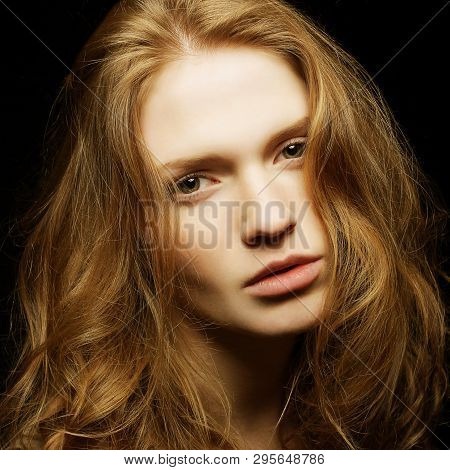 Emotive Portrait Of Young Beautiful Ginger Girl On Black Background. Studio Shot