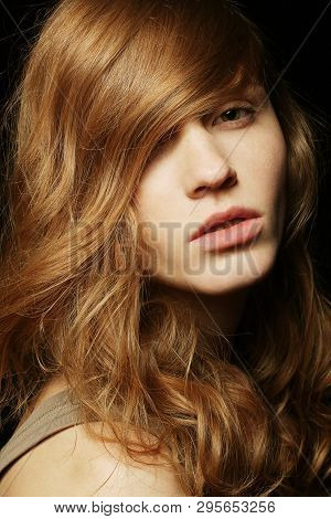 Natural Hairstyle. Healthy Hair. A Beautiful Red-haired Girl Portrait. Studio Shot