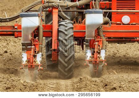 Tractor With Mounted Crop Seeder Planting Corn Seed In Field