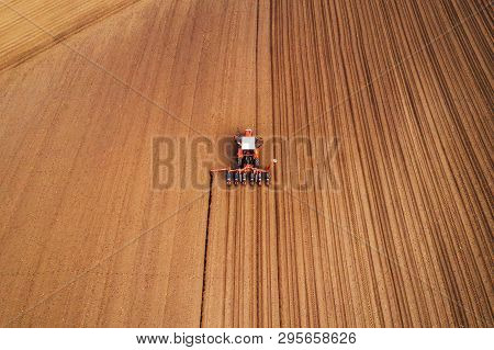 Drone Photography Of Tractor With Seeder Working In Field, Agricultural Machinery Is Planting Seed I