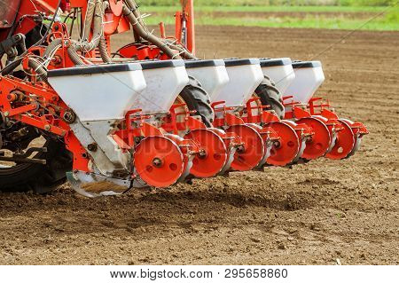 Tractor With Mounted Crop Seeder Planting Corn Seed In Field