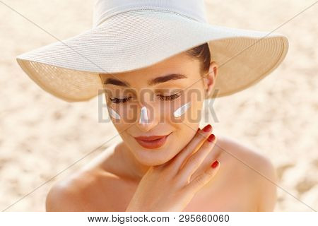 Suncream. Suntan Lotion Beautiful Woman Applying On Beautiful On Face. Sunscreen Solar Cream. Skin C