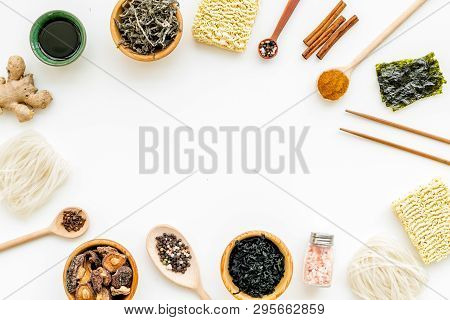 Chinese And Japanese Food Cooking With Ginger, Spices And Noodles Frame On White Background Top View