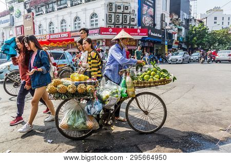 Vietnamise Saleswoman With Bike And Fruits