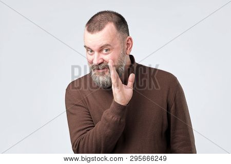 Mature Man With Beard Whispering Gossip To Friend