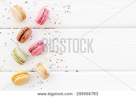 Brignt Macarons For Sweet Break On White Wooden Background Top View Mock Up