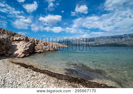 Quiet Bay With Paklenica National Park Mountains In Background. Beautiful Ocean And Dramatic Blue Sk