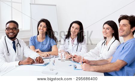 Young Interns Listening To Professor In Conference Room In Hospital