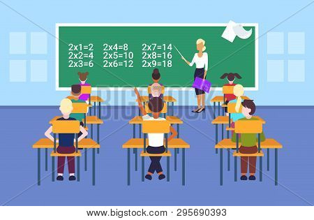 Female Teacher Pointing Chalkboard Pupils Solving Math Problem During Lesson Education Concept Moder