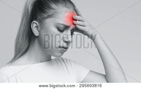 Young Woman Suffering From Terrible Strong Head Pain, Touching Her Forehead, Monochrome Photo With R