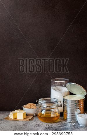 Sea Salt Caramel Candy Ingredients Near A Blackboard To Whrite The Recipe On, Copy Space For Your Te